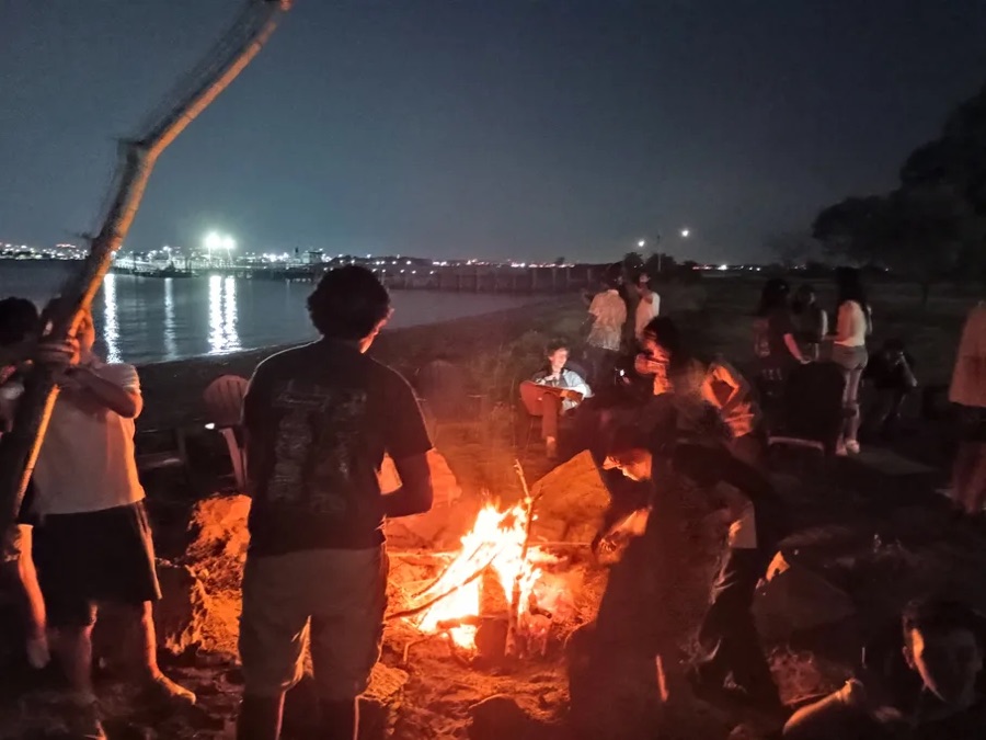A bonfire on a beach at night